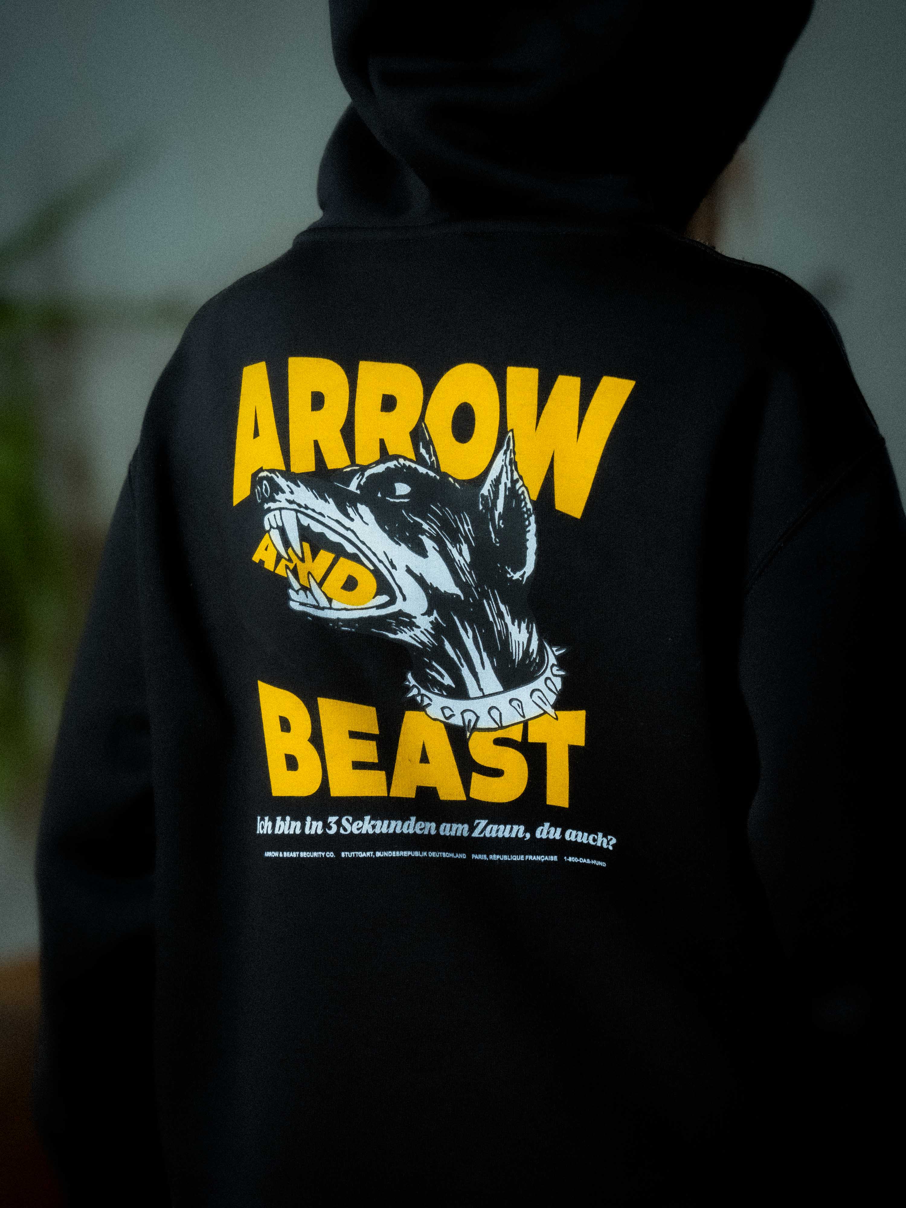 Black hoodie with yellow and white graphic design on the back